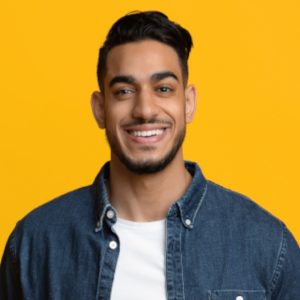 smiling-middle-eastern-man-in-casual-with-laptop-y9ey47v-jpg